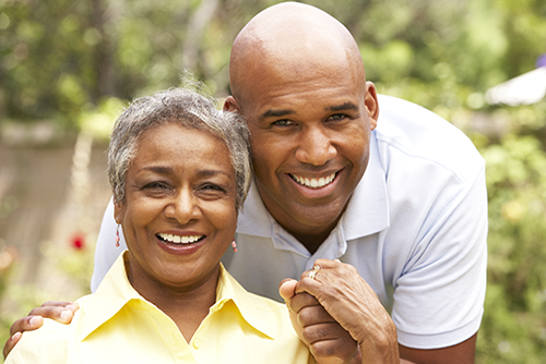 African american mother wearing yellow and son smiling over her shoulder